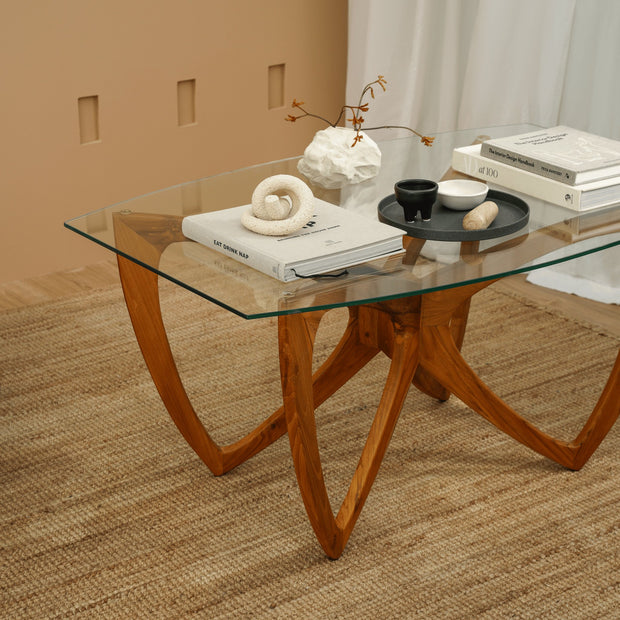 Teak wood coffee table with clear glass surface