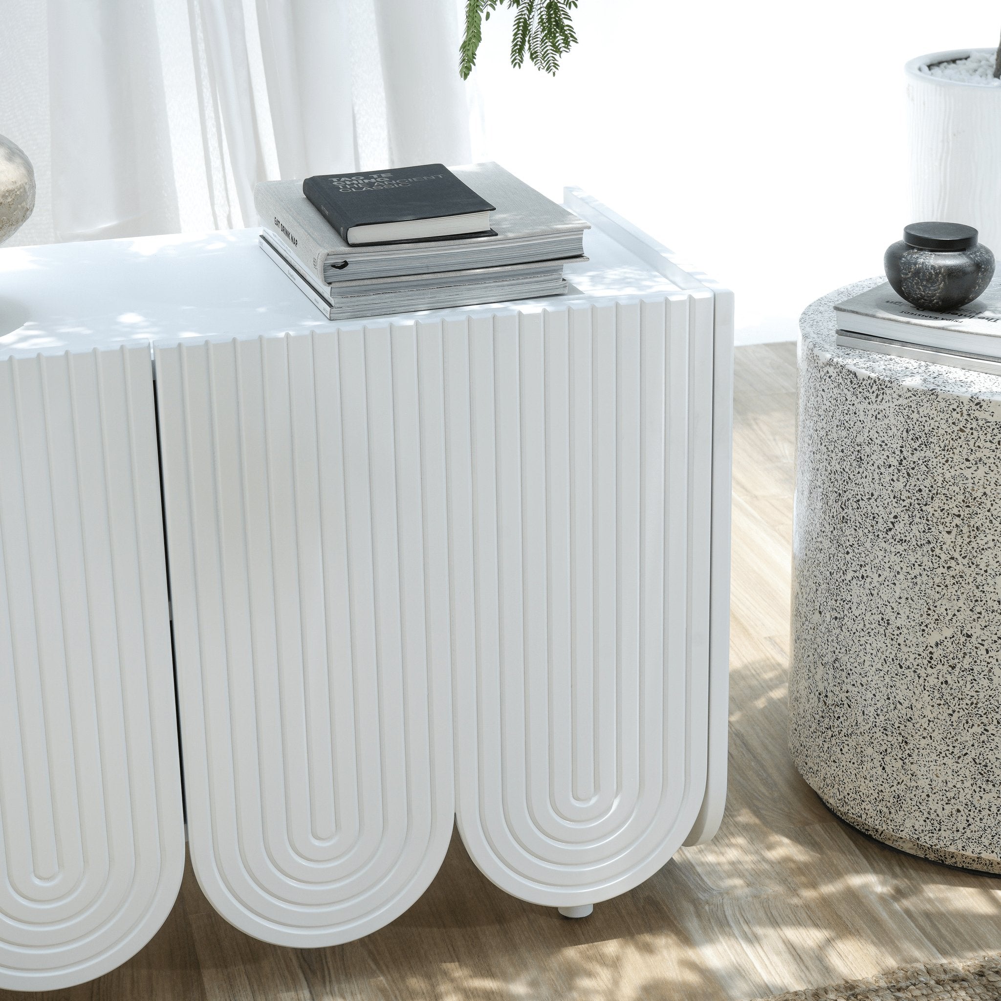 Curved media console with intricate carved detailing